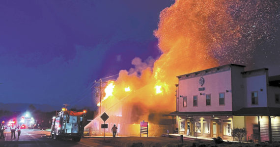 Homer Volunteer Fire Department firefighters attack the East Bunnell Avenue fire at about 3 a.m. Saturday, June 4, 2022, in Homer, Alaska. The Compass Rose building at right had minor damage from heat exposure but otherwise did not burn. (Photo courtesy of Homer Voluntee Fire Department)