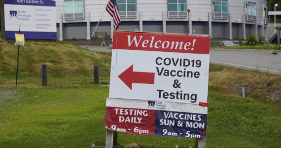 A sign points the way to the South Peninsula Hospital COIVD-19 testing and vaccine clinic at 4201 Bartlett Street on Flag Day, Tuesday, June 14, 2022, in Homer, Alaska. (Photo by Michael Armstrong/Homer News)