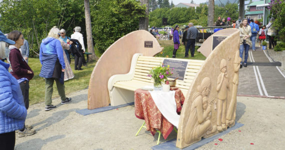 People visit at the Loved & Lost Memorial Bench on Sunday, June 12, 2022, at the Homer Public Library in Homer, Alaska, for a memorial for Anesha "Duffy" Murnane and the dedication of the bench. (Photo by Michael Armstrong/Homer News)