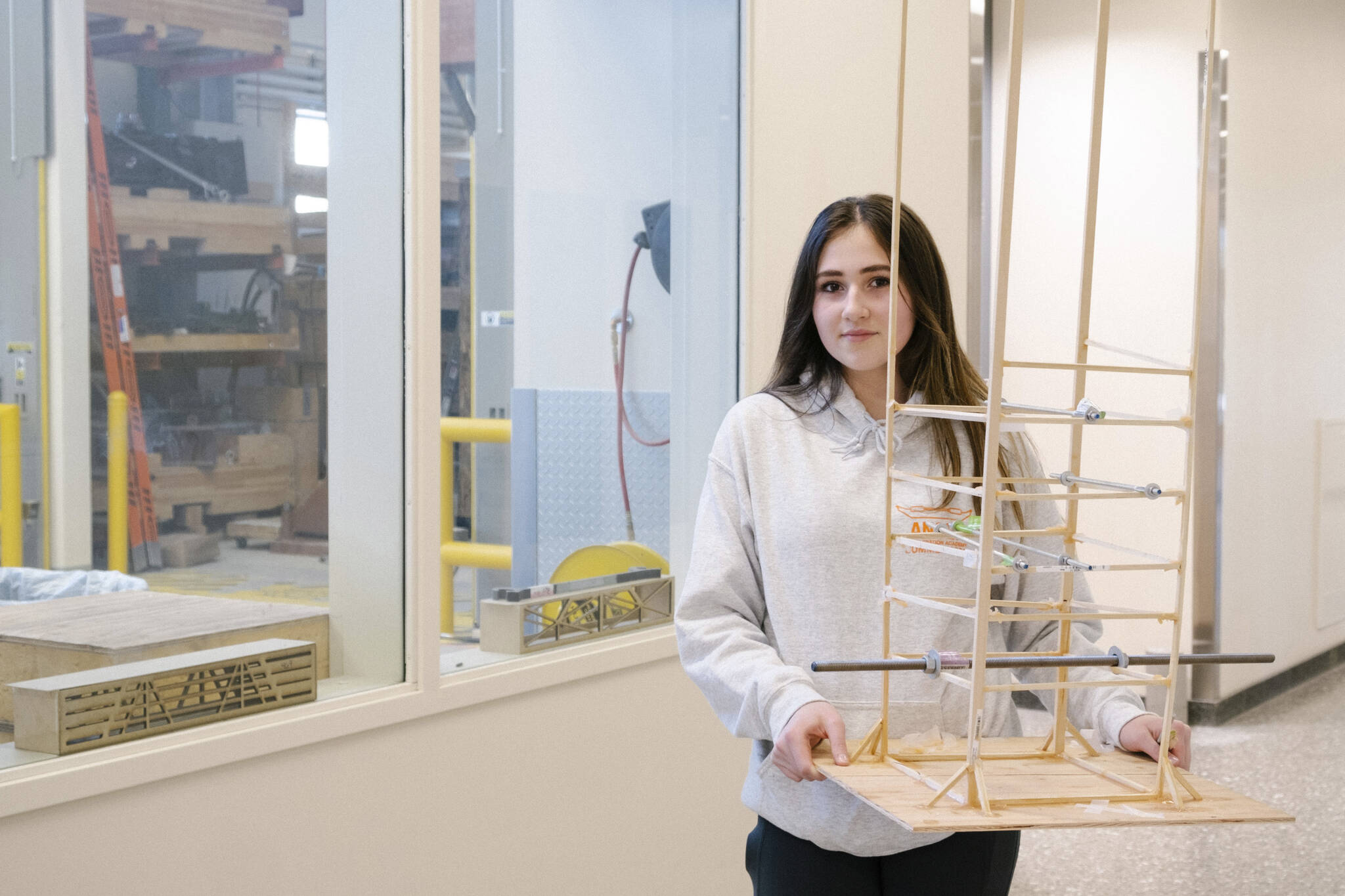 ANSEP Acceleration Academy (Summer) student Alivia Fefelov poses on Tuesday, June 21, at the University of Alaska Anchorage with a balsa tower she helped build to learn about engineering structures to survive earthquakes. The tower withstood a simulated earthquake. (Photo provided)