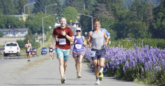 Silas Firth, left, Emily Knight, center, and Craig Albers, right, run past lupines in the 2022 Homer Spit Run 10k and Half Marathon on Saturday, June 25, 2022, in Homer, Alaska. (Photo by Michael Armstrong/Homer News)
Silas Firth, left, Emily Knight, center, and Craig Albers, right, run past lupines in the 2022 Homer Spit Run 10k and Half Marathon on Saturday, June 25, 2022, in Homer, Alaska. (Photo by Michael Armstrong/Homer News)