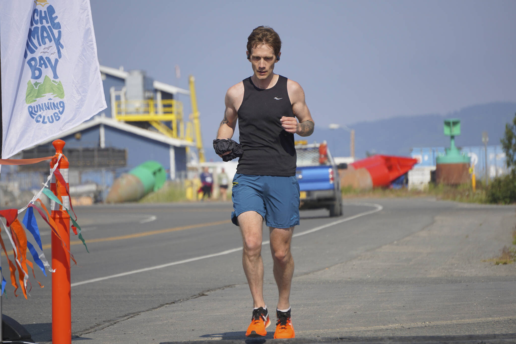 Tim Robinson, the first-place man in the 2022 Homer Spit Run Half Marathon, crosses the finish line on Saturday, June 25, 2022, at the End of the Road Park in Homer, Alaska. (Photo by Michael Armstrong/Homer News)
