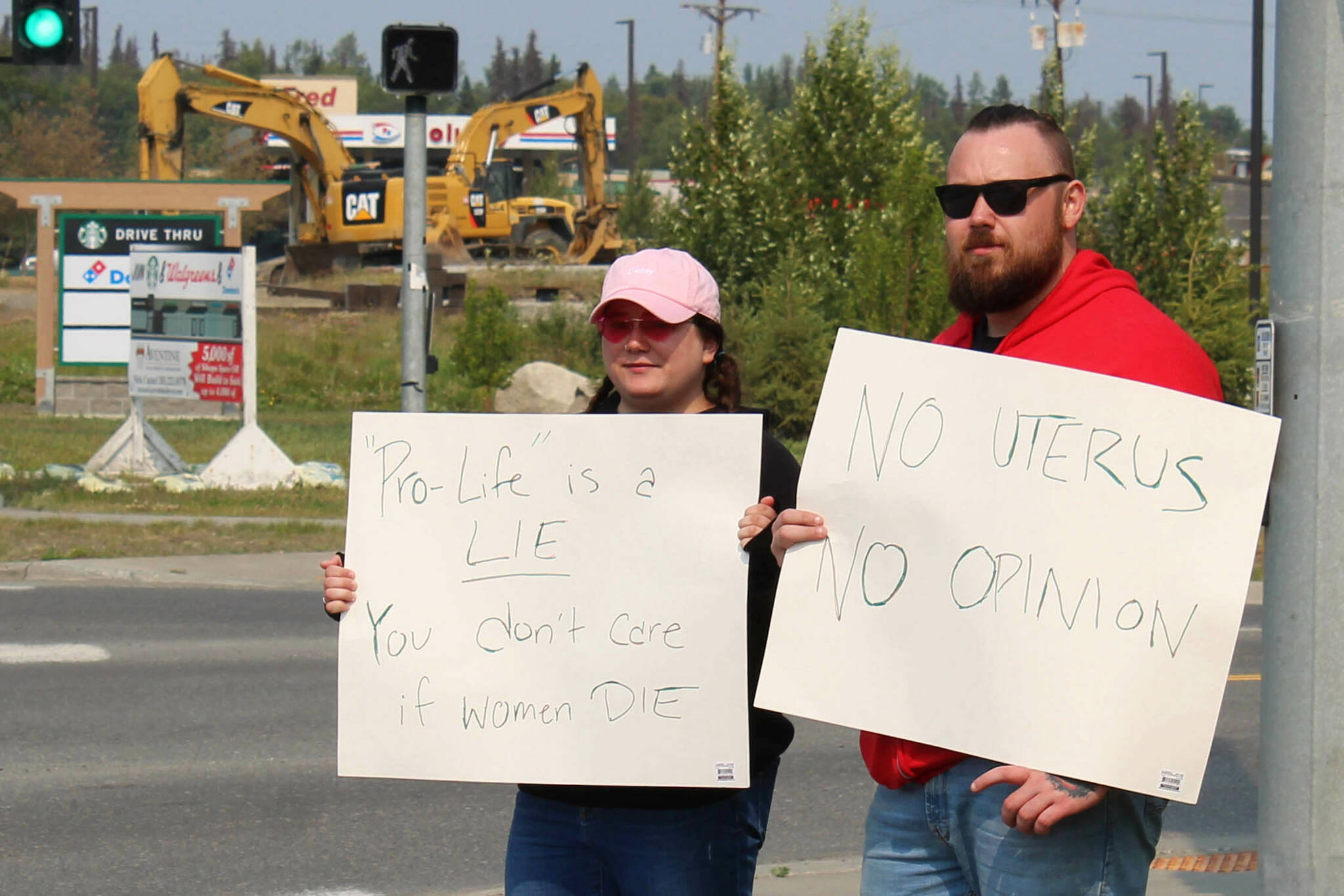 Megan Mitchell (left) and Nick McCoy (right) protest the U.S. Supreme Court’s overturning of Roe v. Wade at the intersection of the Kenai Spur and Sterling highways on Friday, June 24, 2022 in Soldotna, Alaska. (Ashlyn O’Hara/Peninsula Clarion)