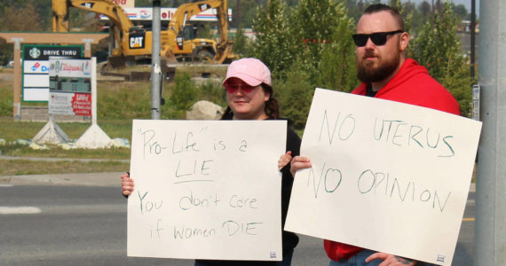 Megan Mitchell, left, and Nick McCoy protest the U.S. Supreme Court’s decision overturning of Roe v. Wade at the intersection of the Kenai Spur and Sterling highways on Friday, June 24, 2022 in Soldotna, Alaska. (Ashlyn O’Hara/Peninsula Clarion)