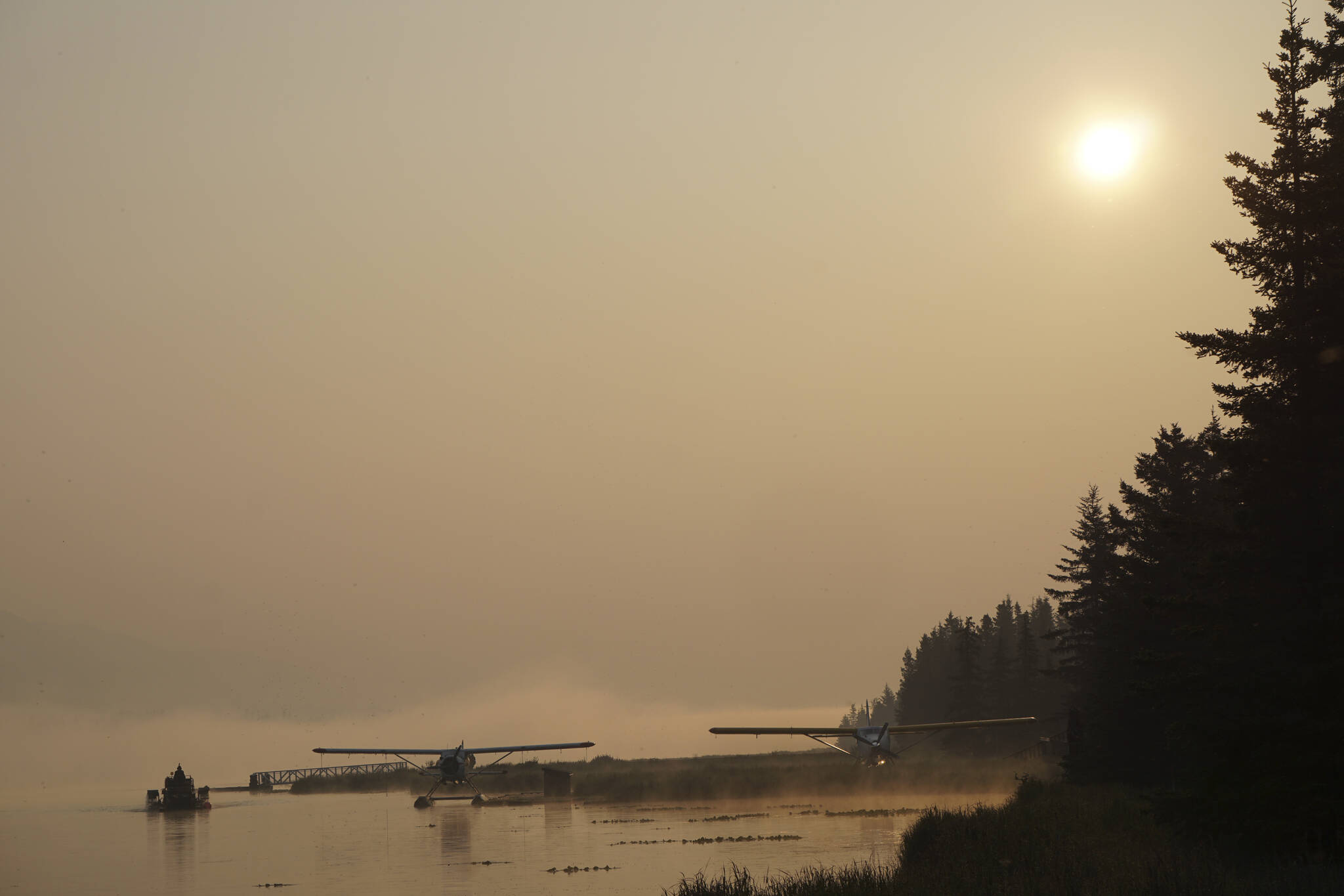 Smoke from wildfires in Southwestern Alaska casts a pall over Beluga Lake on Wednesday morning, June 29, 2022, in Homer, Alaska. (Photo by Michael Armstrong/Homer News)