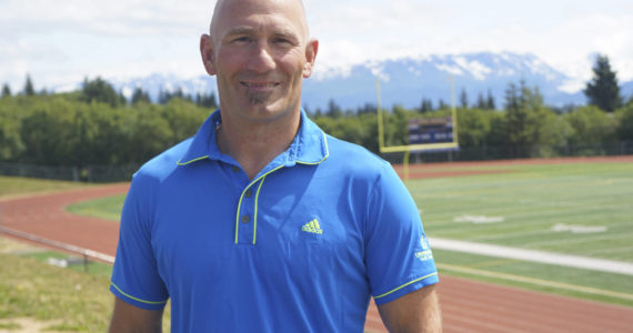 Former Homer High School athletic director poses on Friday, July 1, 2022, at the high school athletic field in Homer, Alaska. (Photo by Michael Armstrong/Homer News)