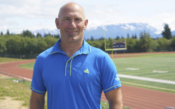 Former Homer High School athletic director poses on Friday, July 1, 2022, at the high school athletic field in Homer, Alaska. (Photo by Michael Armstrong/Homer News)