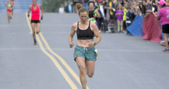 Seward’s Hannah Lafleur leads a trail of runners to the finish to take second in the women’s Mount Marathon Race on Monday, July 4, 2022, in Seward, Alaska. (Photo by Jeff Helminiak/Peninsula Clarion)