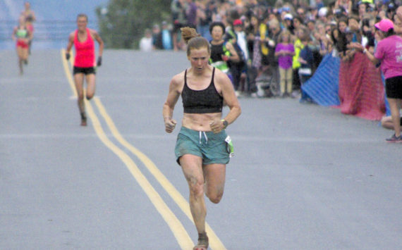 Seward’s Hannah Lafleur leads a trail of runners to the finish to take second in the women’s Mount Marathon Race on Monday, July 4, 2022, in Seward, Alaska. (Photo by Jeff Helminiak/Peninsula Clarion)