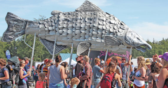 A giant silver salmon is paraded through Salmonfest on Saturday, Aug. 3, 2019, in Ninilchik, Alaska. (Photo by Megan Pacer/Homer News)