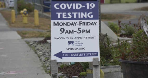 A new sign on July 2, 2022, on Pioneer Avenue and Bartlett Street indicates the new times and days for the South Peninsula Hospital COVID-19 testing and vaccine clinic on Bartlett Street. (Photo by Michael Armstrong/Homer News)