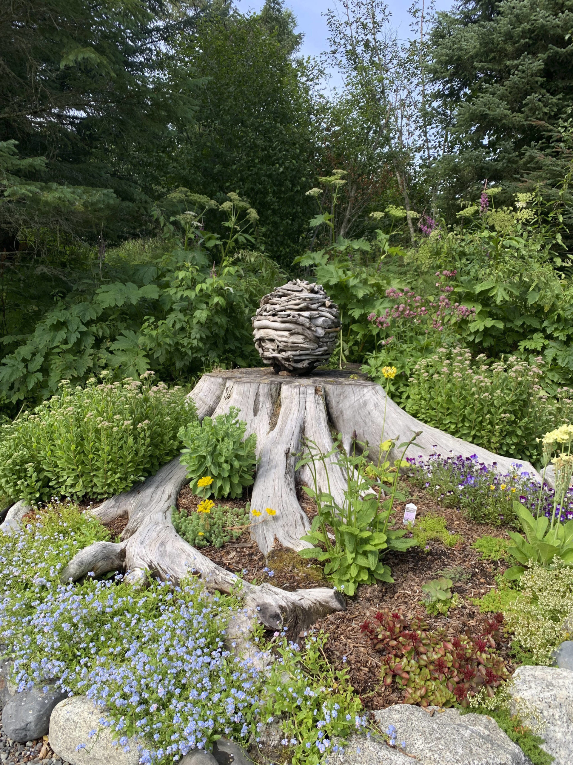A garden at the home of Ralph Broshes and Deb Lowney features one of Lowney’s sculptures. It was part of the walking tour portion of the Homer Garden Tour on Sunday, July 17, in Homer, Alaska. (Photo by Charlie Menke/Homer News)