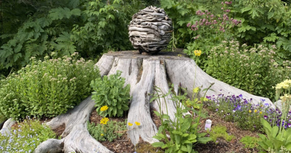 A garden at the home of Ralph Broshes and Deb Lowney features one of Lowney's sculptures. It was part of the walking tour portion of the Homer Garden Tour on Sunday, July 17, in Homer, Alaska.  (Photo by Charlie Menke/Homer News)