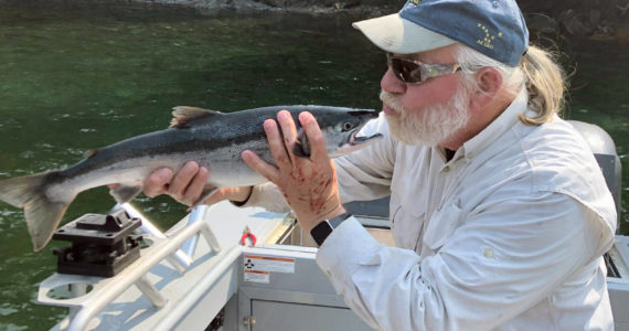 Bill shows his appreciation for the Kenai sockeye after a successful evening fishing trip with friends, new and old. (Photo provided by USFWS)