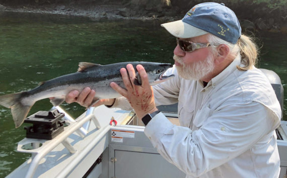Bill shows his appreciation for the Kenai sockeye after a successful evening fishing trip with friends, new and old. (Photo provided by USFWS)