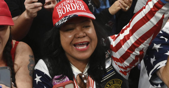 Mimi Israelah, center, cheers for Donald Trump inside the Alaska Airlines Center in Anchorage, Alaska, during a rally Saturday July 9, 2022. An investigation has been launched after a person believed to be an Anchorage, Alaska, police officer was shown in a photo with Israelah flashing a novelty “White Privilege card.” The social media post caused concerns about racial equality in Alaska’s largest city. (Bill Roth / Anchorage Daily News)