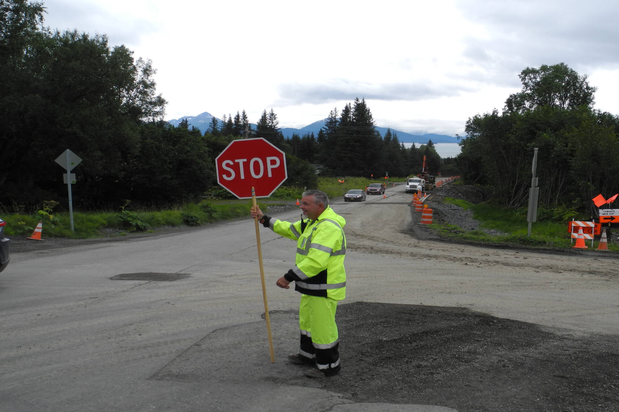 Flagger stops traffic at East Hill Road on Monday, July 25, 2022, in Homer, Alaska. (Photo by Charlie Menke/Homer News)