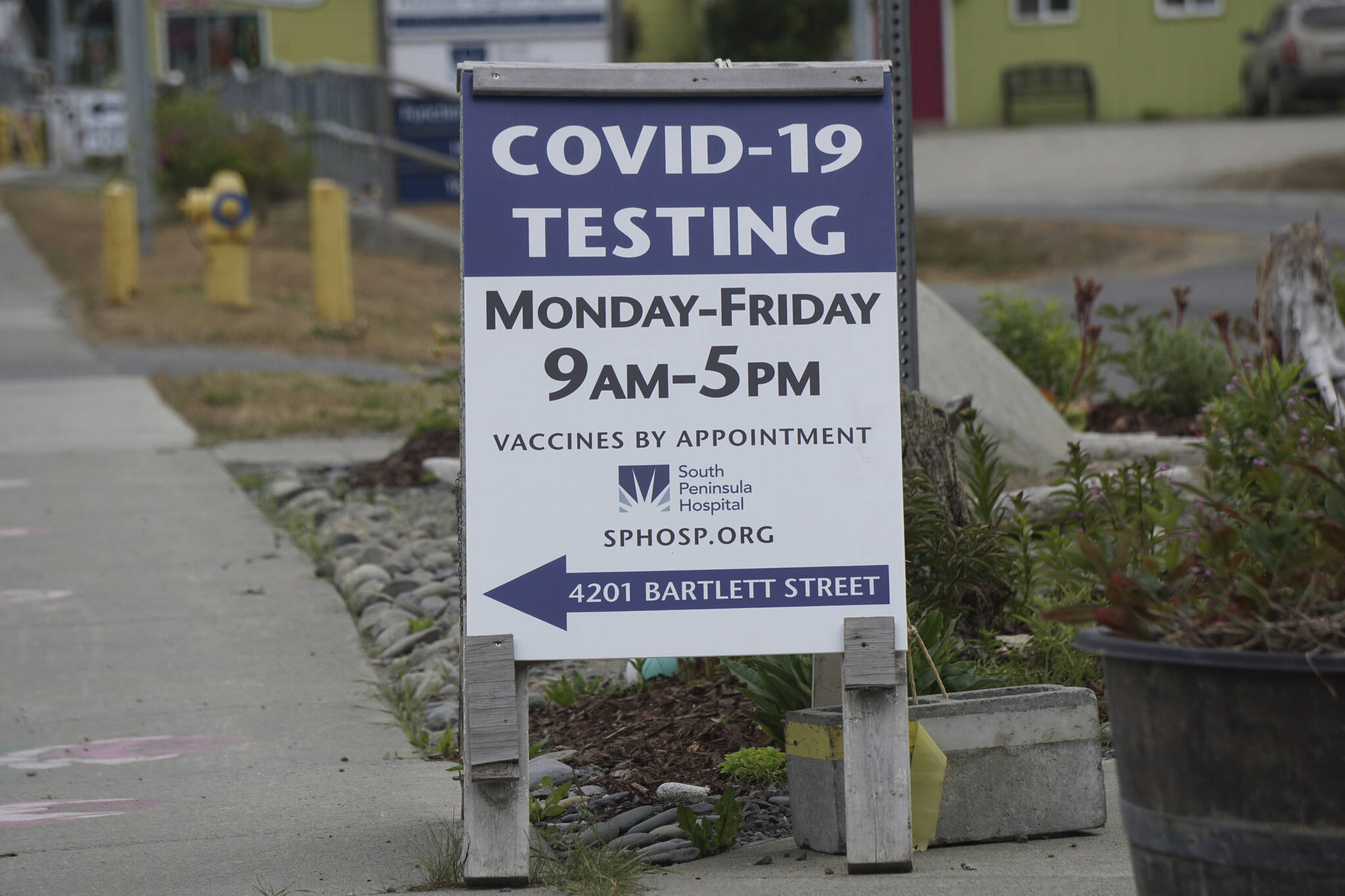 A new sign on July 2, 2022, on Pioneer Avenue and Bartlett Street indicates the new times and days for the South Peninsula Hospital COVID-19 testing and vaccine clinic on Bartlett Street. (Photo by Michael Armstrong/Homer News)
