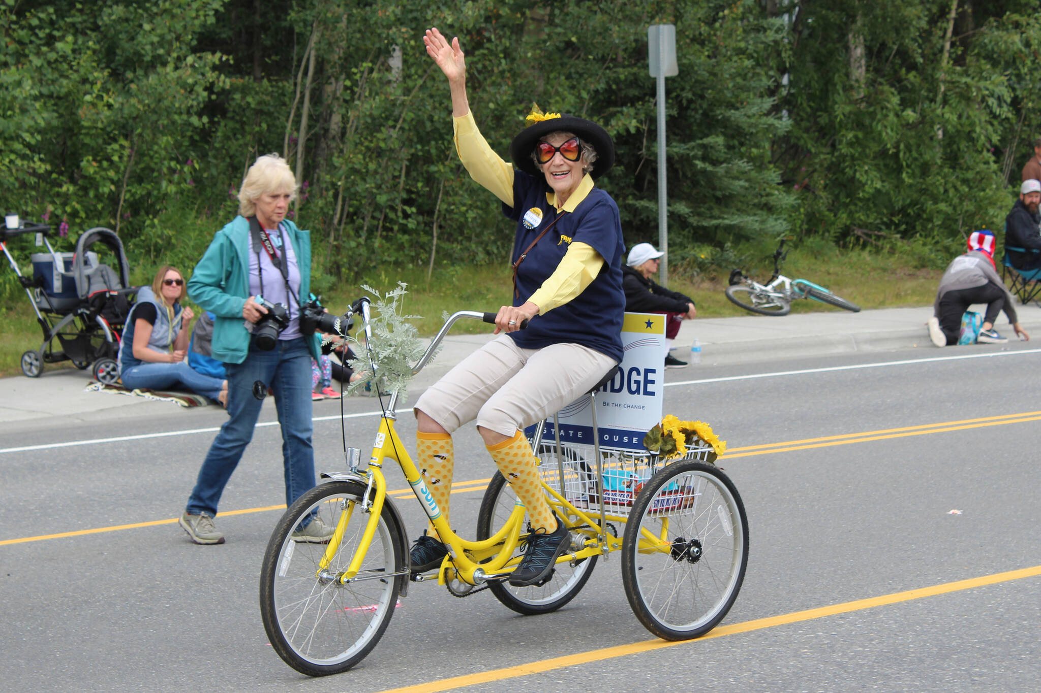 A supporter of 2022 Alaska State House candidate Justin Ruffridge waves during the 65th annual Soldotna Progress Days Parade on Saturday, July 23, 2022, in Soldotna, Alaska. (Ashlyn O’Hara/Peninsula Clarion)