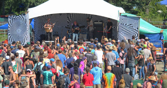 Music lovers listen to a performance on the River Stage at Salmonfest on Saturday, Aug. 4, 2018, in Ninilchik, Alaska. (Photo by Megan Pacer/Homer News)