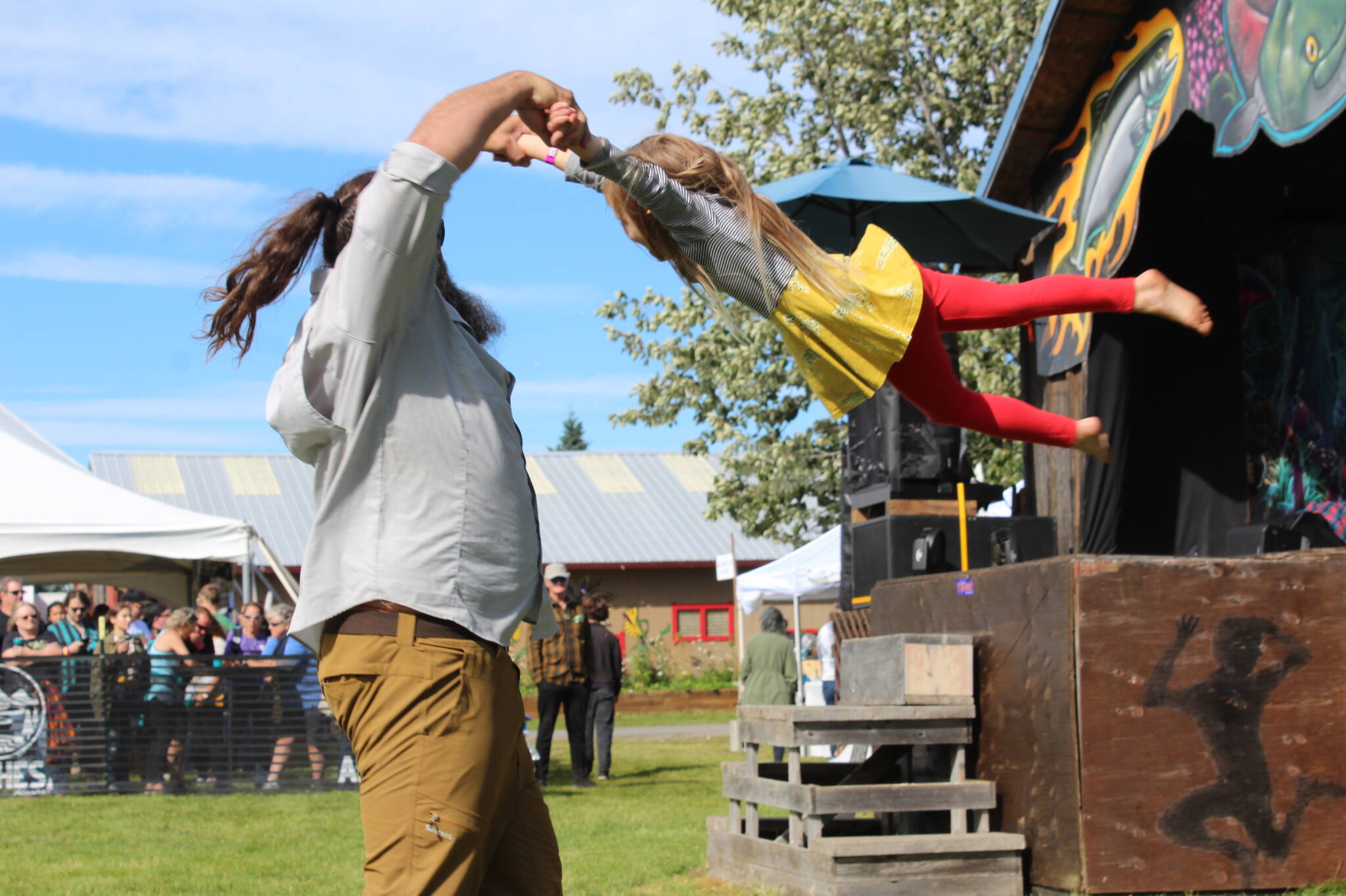 People gather in Ninilchik, Alaska on Friday, Aug. 5, 2022, for Salmonfest, an annual event that raises awareness about salmon-related causes. (Camille Botello/Peninsula Clarion)
