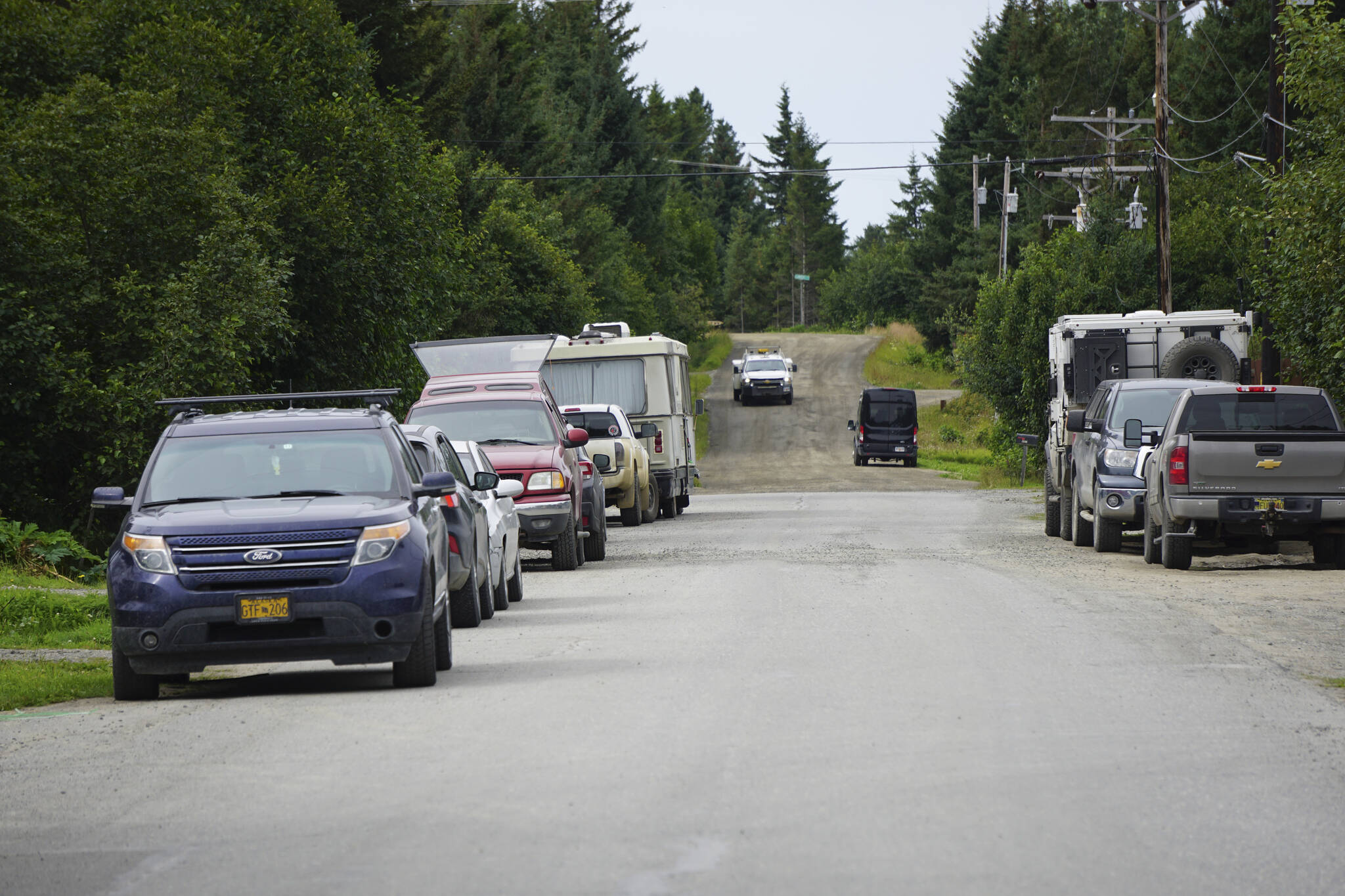 Vehicles are parked in or near the road on Thursday, Aug. 4, 2022, on Lakeshore Drive in Homer, Alaska. An ordinance passed by the Homer City Council on Monday, Aug. 8, 2022, made it unlawful to push snow into roads and city right-of-ways and to park vehices or leave other objects that interfere with snow removal or road maintenance in city roads, paths, sidewalks or drainage ways or structures. (Photo by Michael Armstrong/Homer News)
