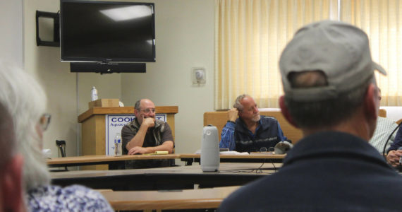 Alaska Department of Fish and Game Commissioner Doug Vincent-Lang, right, listens to east side setnet fisherman at the Cook Inlet Aquaculture Association building on Tuesday, Aug. 2, 2022, near Kenai, Alaska. (Ashlyn O’Hara/Peninsula Clarion)