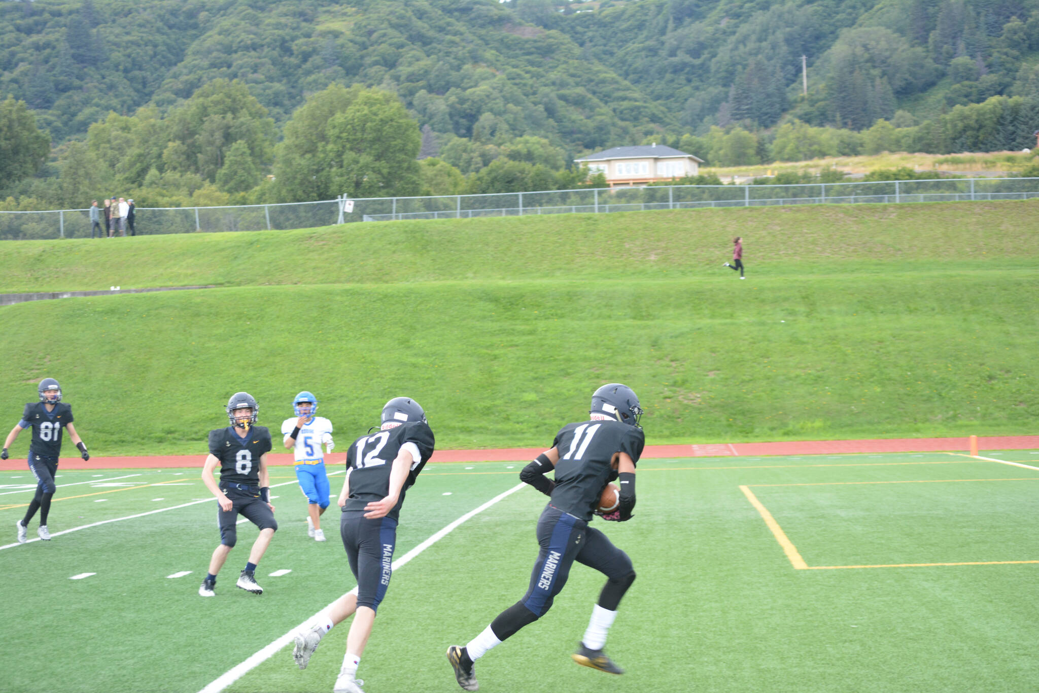 Techie carries the ball into the endzone after a stellar catch on Saturday, Aug. 13, 2022, at Homer High School in Homer, Alaska. (Photo by Charlie Menke/ Homer News)