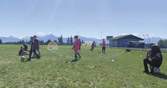 Kids playing soccer on a sunny summer day. (Photo by Charlie Menke/ Homer News)