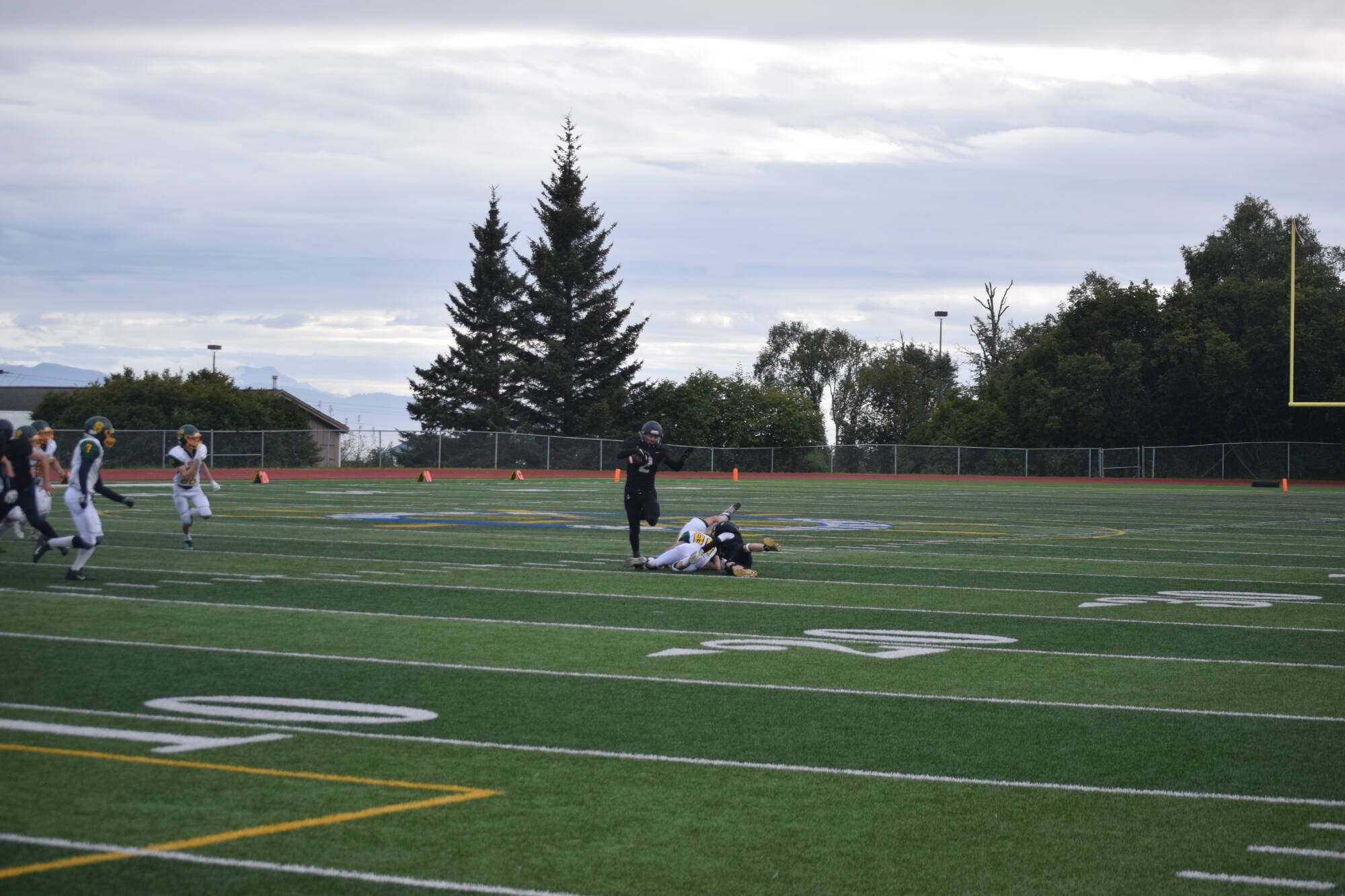 Junior Chris Martishev escapes defensive pressure on Friday, Aug. 26 at Homer High School Field in Homer, Alaska. (Photo by Charlie Menke/Homer News)