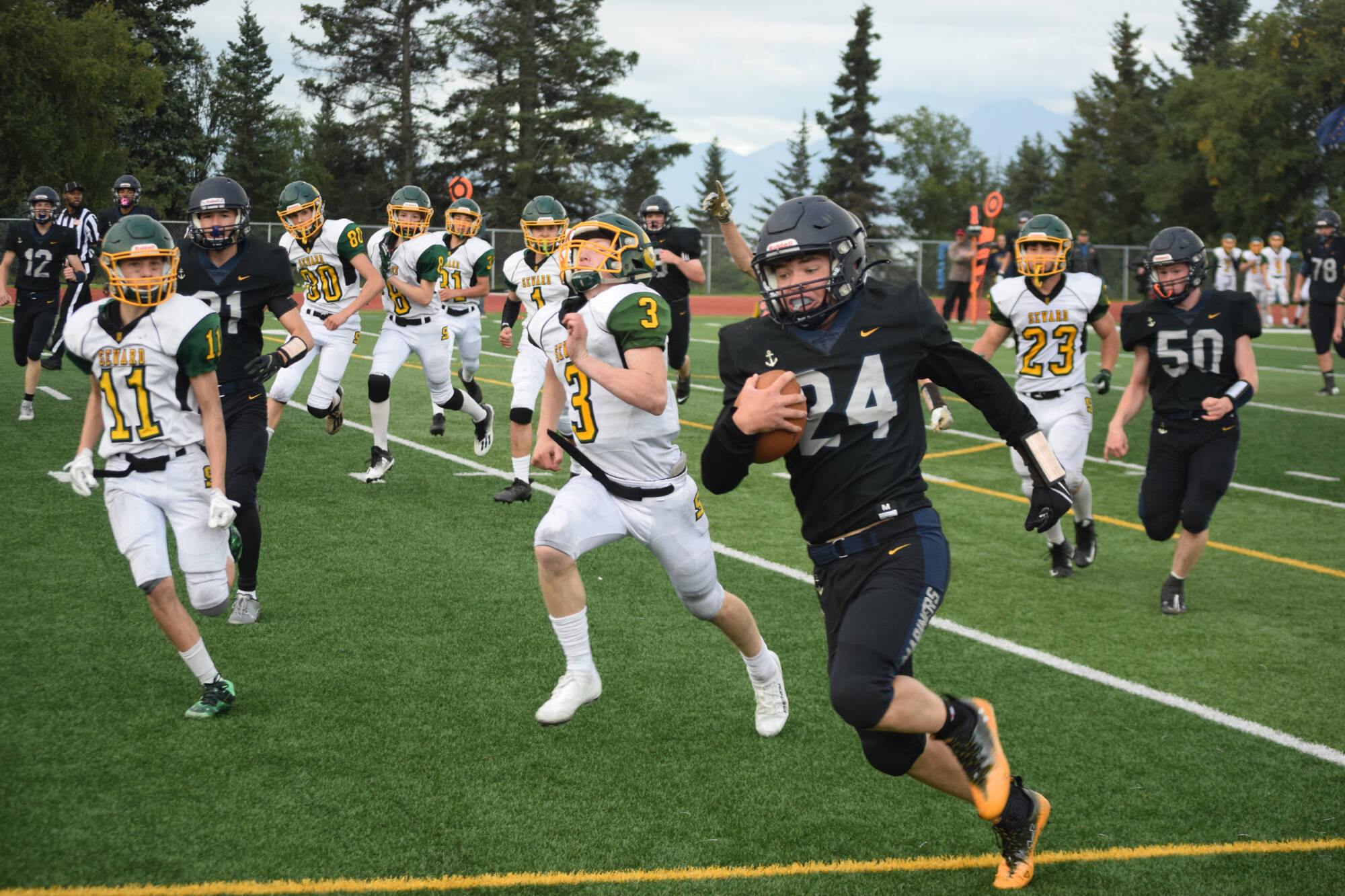 Preston Stanislaw attempts a touchdown rush on Friday, Aug. 26 at Homer High School Field in Homer, Alaska. (Photo by Charlie Menke/Homer News)