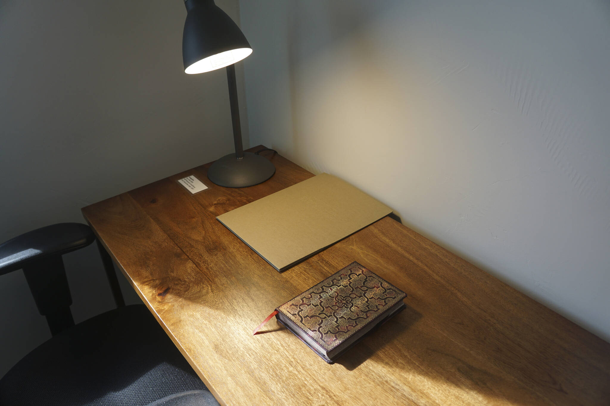 A journal rests on the writing desk of Evangeline, one of the Storyknife Writers Retreat cabins, at an open house on Monday, Aug. 29, 2022, at the retreat near Homer, Alaska. (Photo by Michael Armstrong/Homer News)