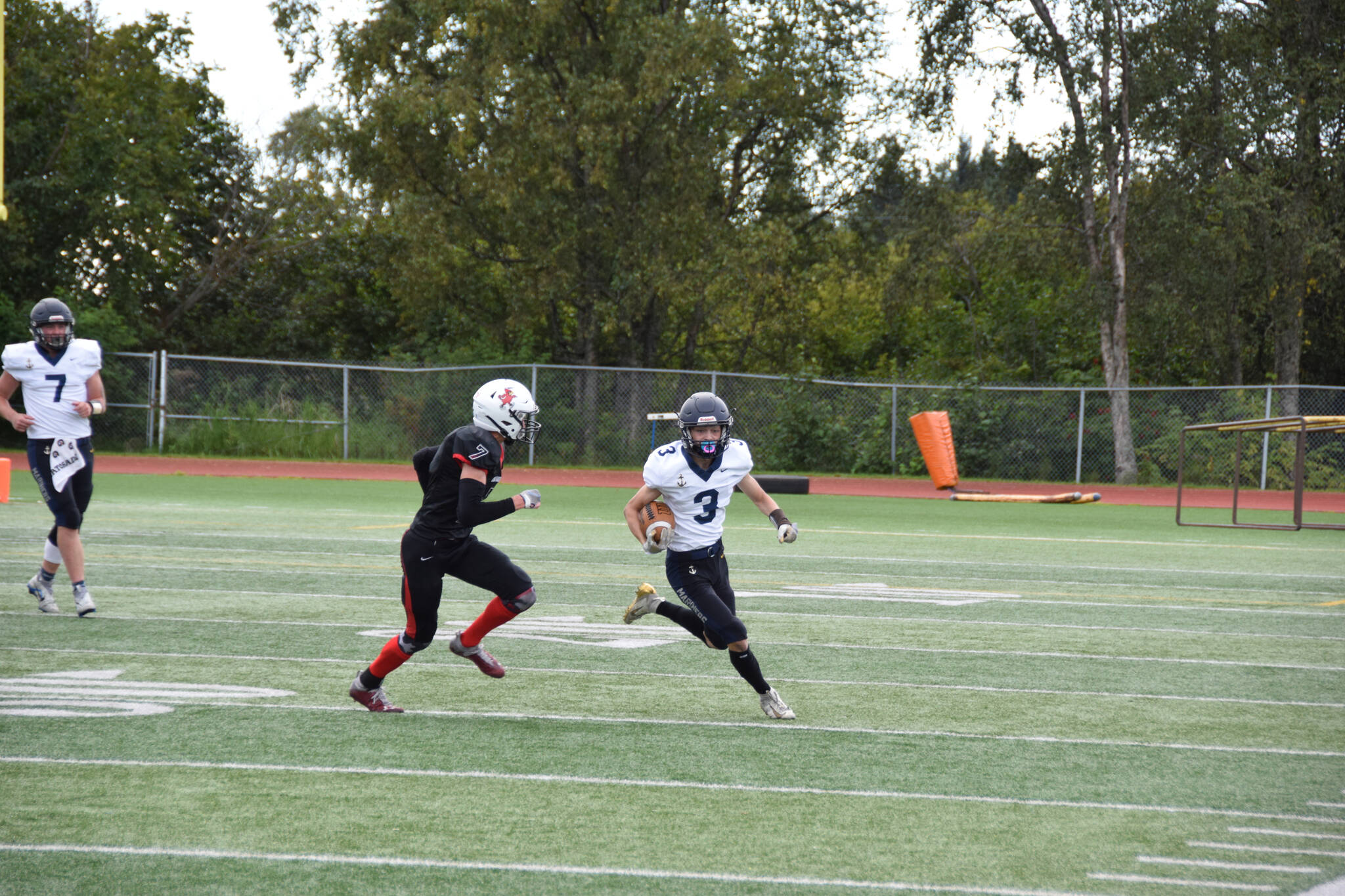 Wide receiver Jonah Martin carries the ball upfield on Saturday, Sep. 3, at the Homer High School Field in Homer, Alaska. (Photo by Charlie Menke/ Homer News)
