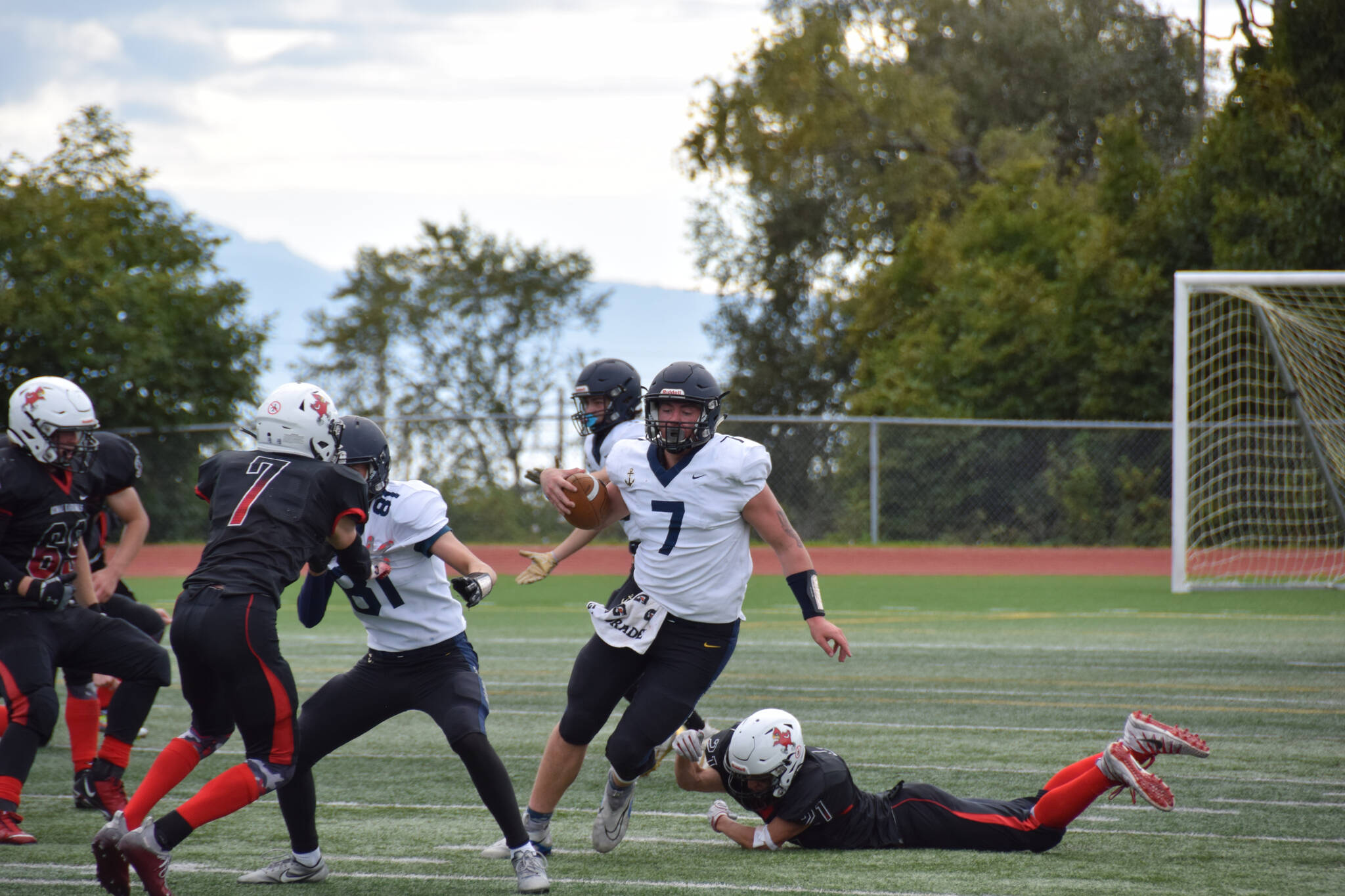 Tennison evades a diving tackle on Saturday, Sep. 3, at the Homer High School Field in Homer, Alaska. (Photo by Charlie Menke/ Homer News)