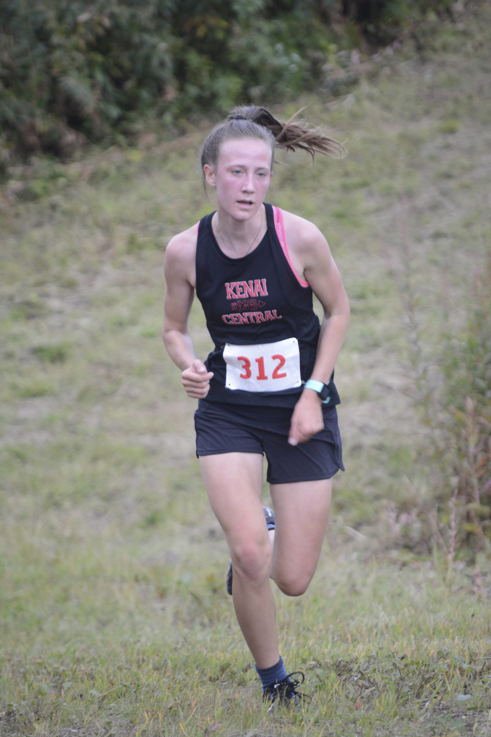 Jayna Boonstra of Kenai Central comes down the last hill to win the Homer Invite on Friday, Sept. 2, 2022, at the Lookout Mountain Trails near Homer, Alaska. (Photo by Michael Armstrong/Homer News)
