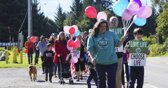 People with Walk for Life march up Bartlett Street to the Water's Edge crisis pregnancy clinic on Monday, Sept. 5, 2022, in Homer, Alaska. About 140 people walked from the Assembly of God Church and Glacier View Baptist Church on East End Road along Pioneer Avenue and up Bartlett Street to show their support for pro-life efforts and opposition to abortion. (Photo by Michael Armstrong/Homer News)