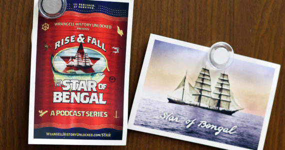 Postcards promoting a new podcast about the Star of Bengal hang on a Juneau refrigerator. (Ben Hohenstatt / Capital City Weekly)