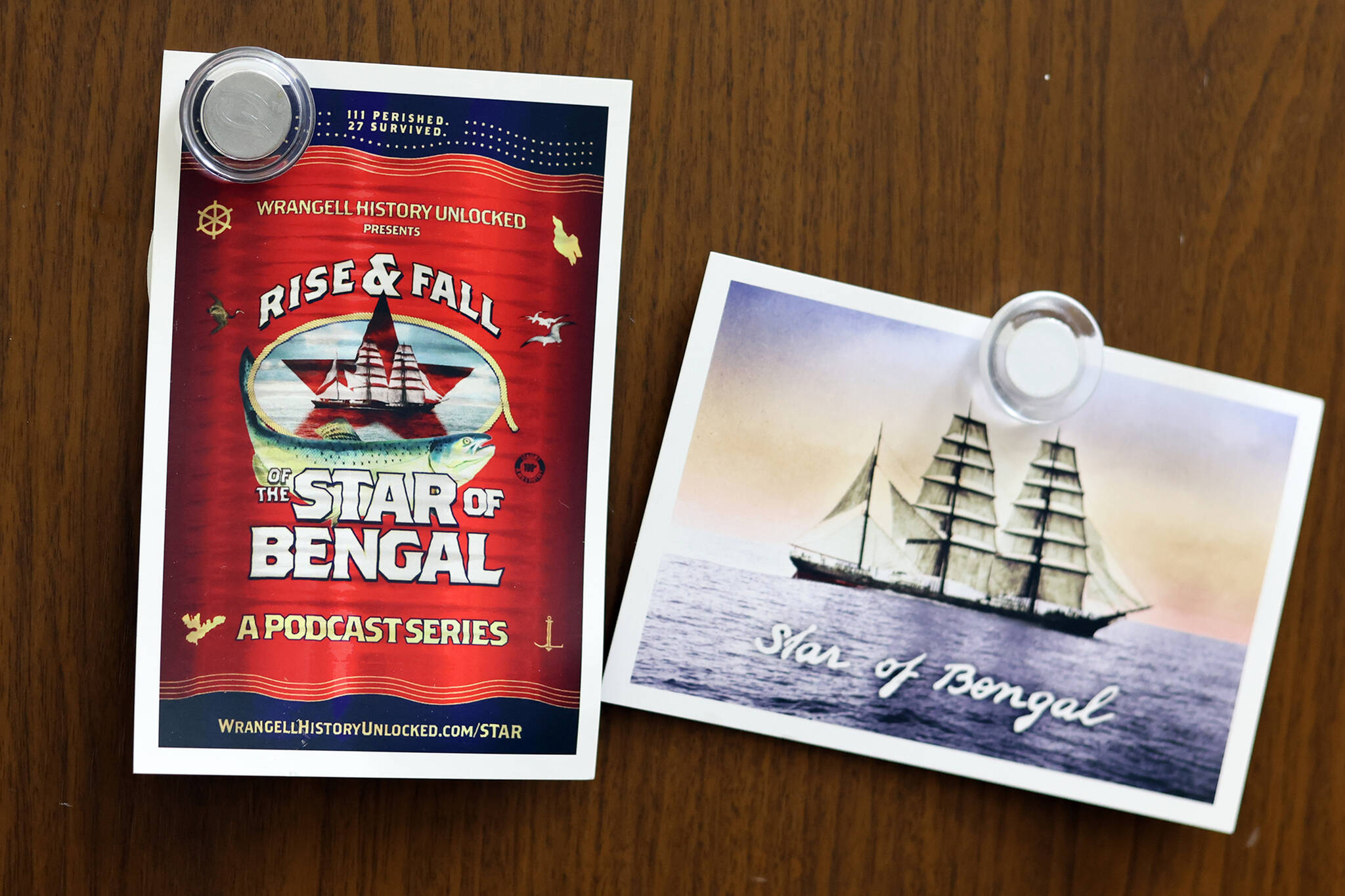 Postcards promoting a new podcast about the Star of Bengal hang on a Juneau refrigerator. (Ben Hohenstatt / Capital City Weekly)