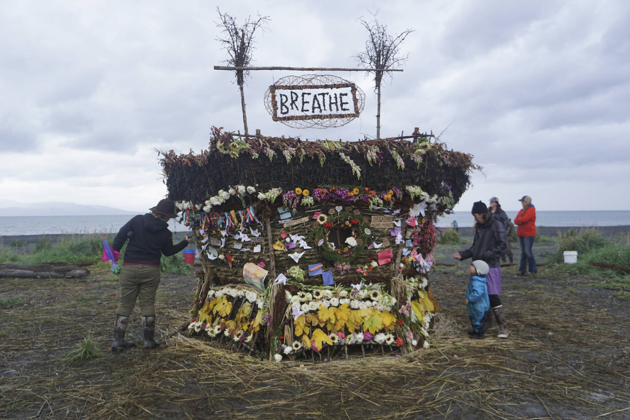 People interact with the 19th annual Burning Basket, “Breathe,” on Sunday, Sept. 11, 2022, at Mariner Park on the Homer Spit in Homer, Alaska. (Photo by Michael Armstrong/Homer News)