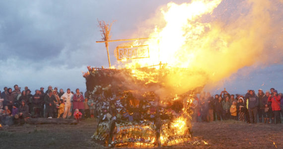 As about 200 people watch, the 19th annual Burning Basket, "Breathe," catches fire on Sunday, Sept. 11, 2022, at Mariner Park on the Homer Spit in Homer, Alaska. (Photo by Michael Armstrong/Homer News)