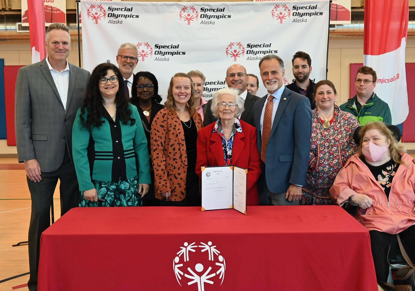 Gov. Mike Dunleavy, Heidi Lieb-Williams, Madison Govin, Madeline Micciche, Peter Micciche and others celebrate the signing of Senate Bill 185 into law at Special Olympics Alaska in Anchorage, Alaska, on Tuesday, Sept. 13, 2022. (Photo courtesy Alaska Office of the Governor)