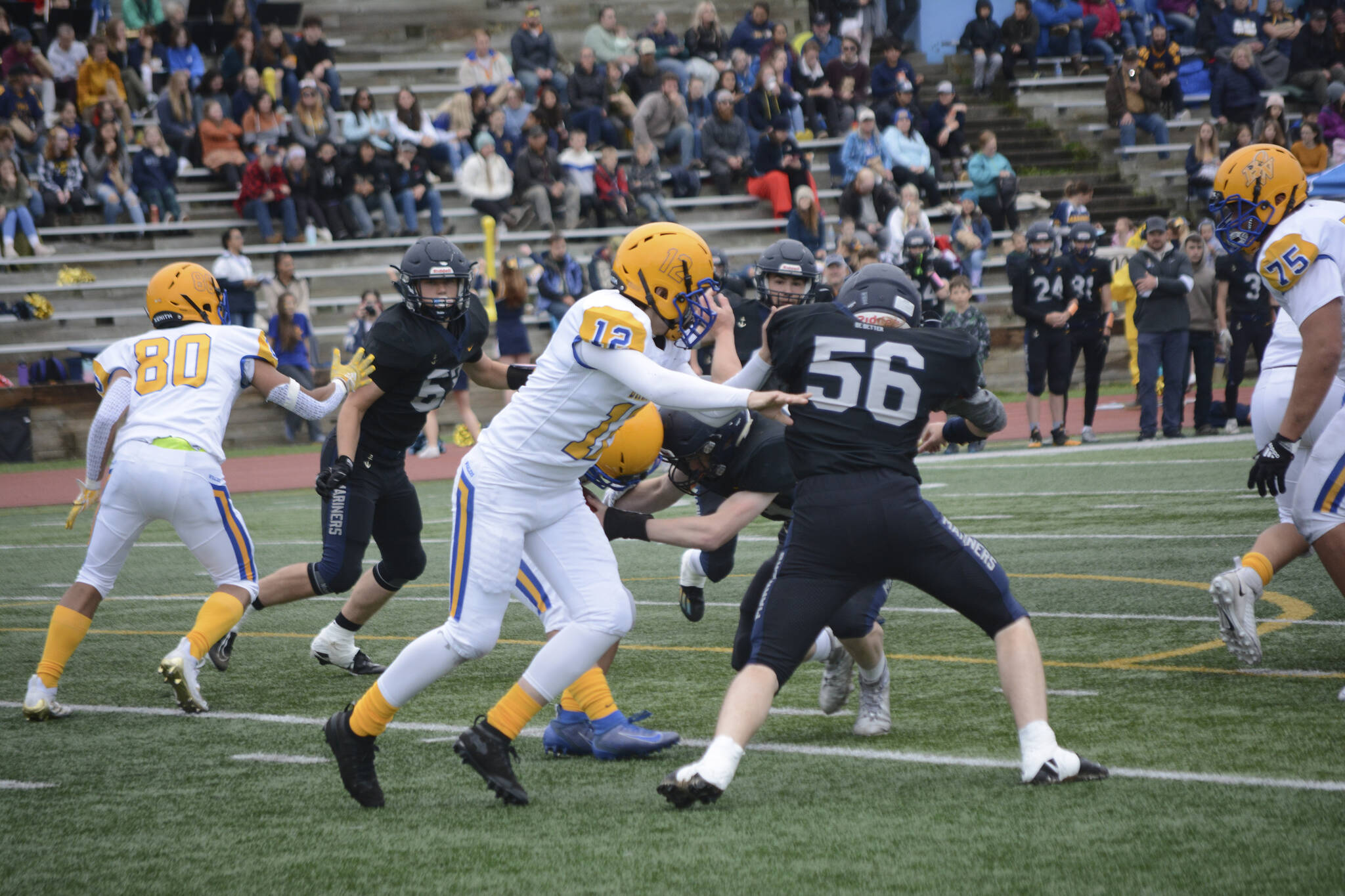 Mariner Coleman Stephens tries to block Barrow Whaler Ethan Goodwin at homecoming on Friday, Sept. 16, 2022, in Homer, Alaska. (Photo by Michael Armstrong/Homer News)