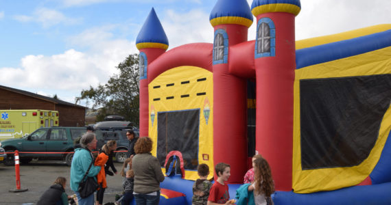 Kids bounce in an inflatable castle at the Kachemak City Park Grand Opening on Saturday, Sept. 17, 2022. (Photo by Charlie Menke / Homer News)