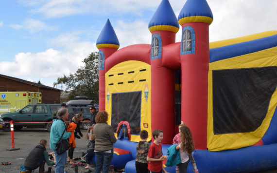 Kids bounce in an inflatable castle at the Kachemak City Park Grand Opening on Saturday, Sept. 17, 2022. (Photo by Charlie Menke / Homer News)