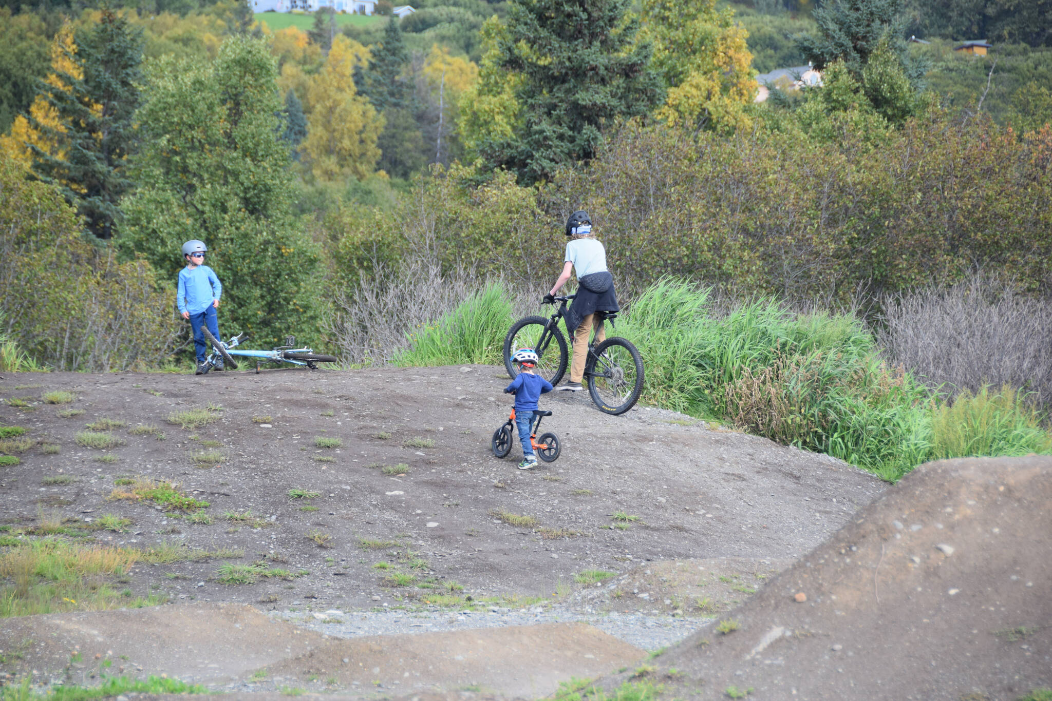 Kids play in the dirt bike area at the Kachemak City Park Grand Opening on Saturday, Sept. 17, 2022. (Photo by Charlie Menke / Homer News)