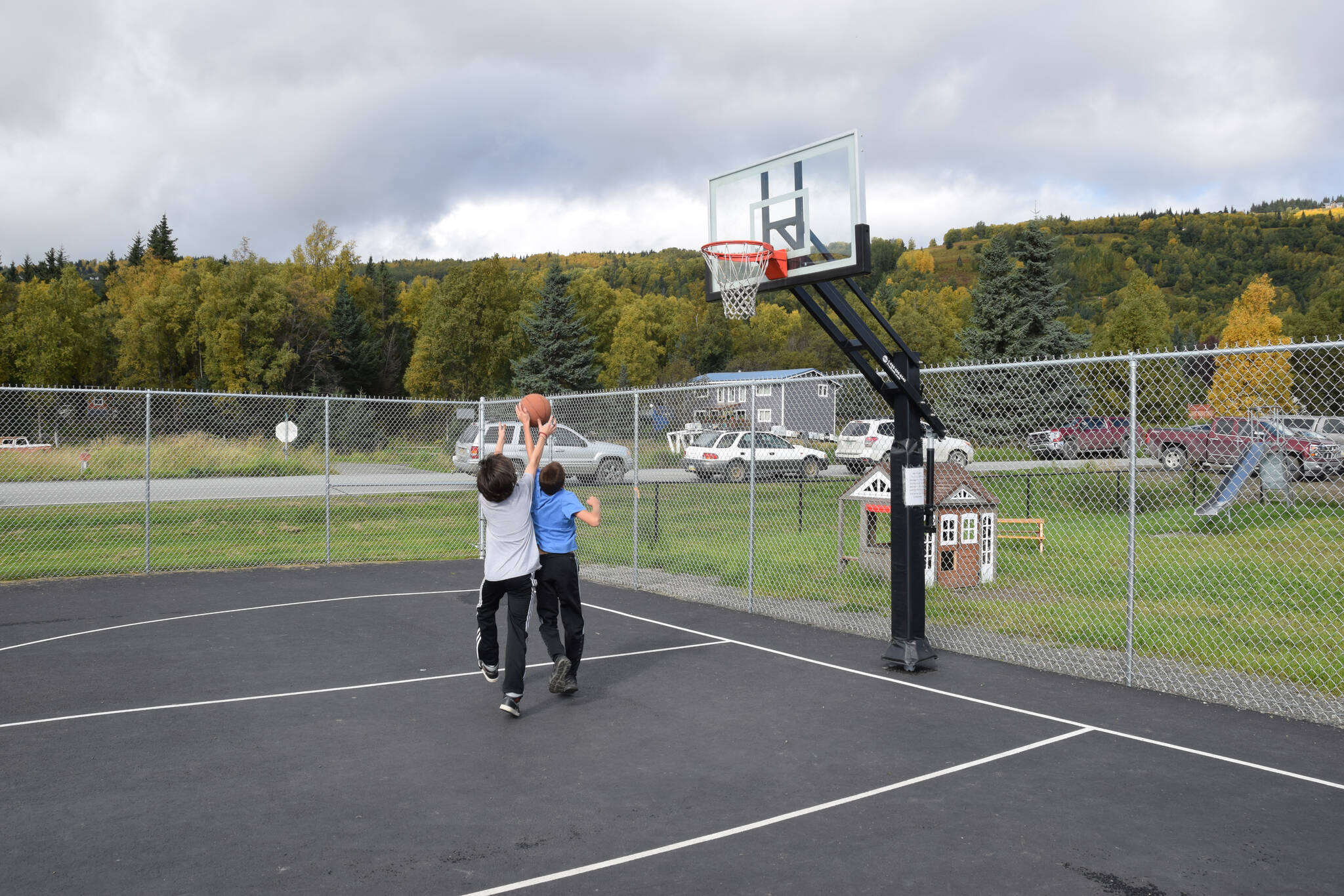 Kids play basketball at the Kachemak City Park Grand Opening on Saturday, Sept. 17, 2022. (Photo by Charlie Menke / Homer News)