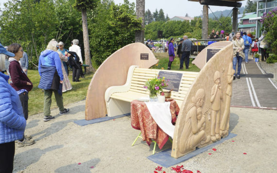 People visit at the Loved & Lost Memorial Bench on Sunday, June 12, 2022, at the Homer Public Library in Homer, Alaska, for a memorial for Anesha "Duffy" Murnane and the dedication of the bench. (Photo by Michael Armstrong/Homer News)