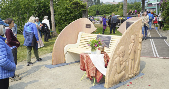 People visit at the Loved & Lost Memorial Bench on Sunday, June 12, 2022, at the Homer Public Library in Homer, Alaska, for a memorial for Anesha “Duffy” Murnane and the dedication of the bench. (Photo by Michael Armstrong/Homer News)