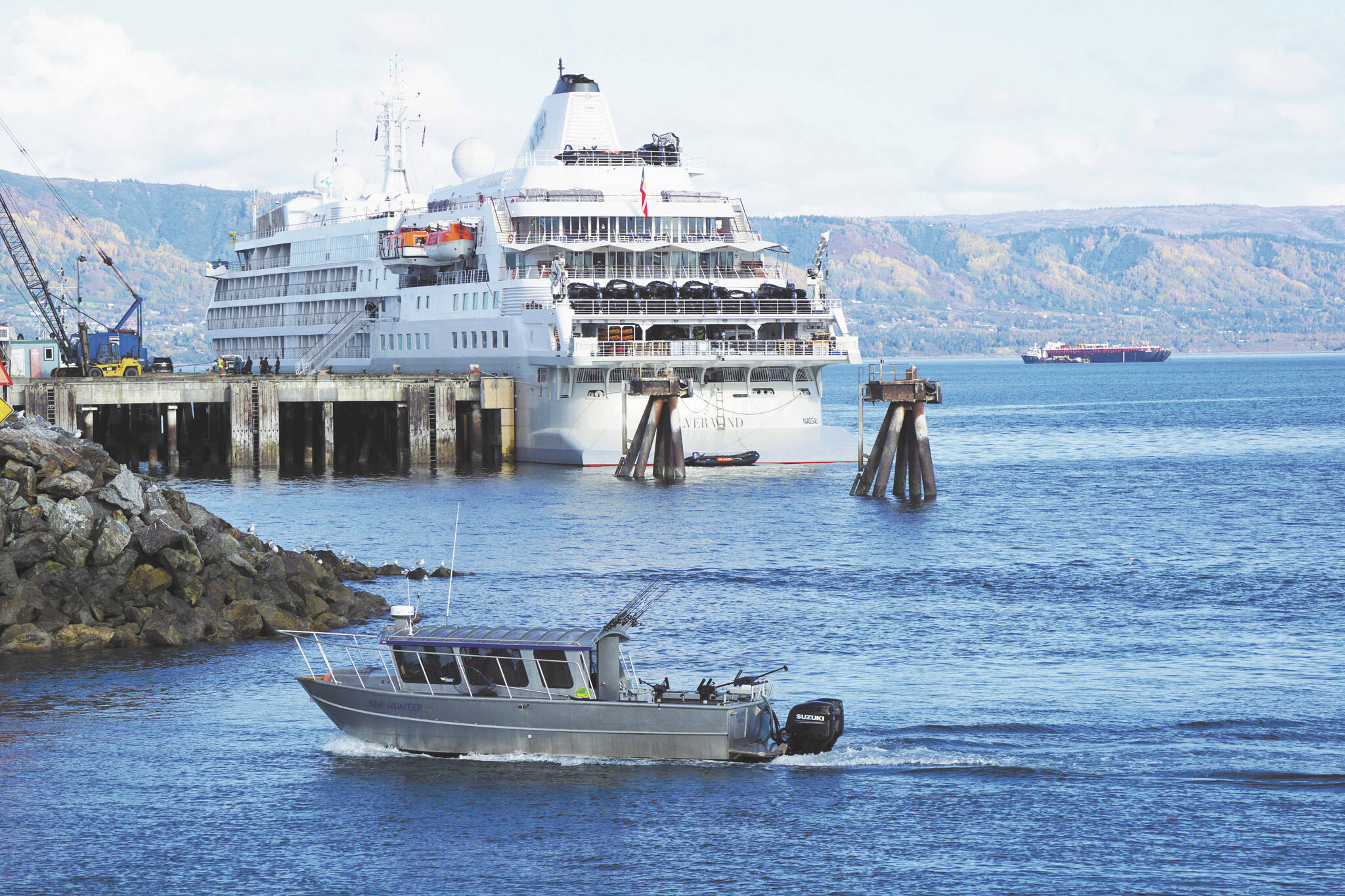 Photo by Michael Armstrong/Homer News 
A fishing boat passes the Silversea cruise ship Silver Wind as the boat enters the Homer Harbor on Sunday, Sept. 25, 2022, in Homer, Alaska.