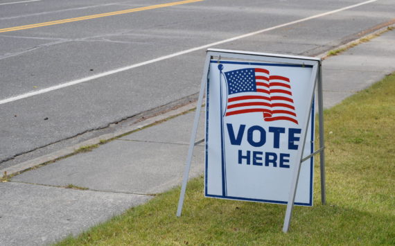 A “Vote Here” sign is seen outside of the City of Kenai Building on Monday, Sept. 21, 2020, in Kenai, Alaska.